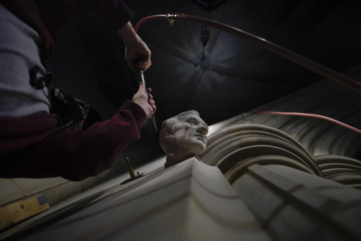 Washington National Cathedral stone carver Sean Callahan uses an air chisel to work on a sculpture of Holocaust survivor and Nobel Peace Prize winning author Elie Wiesel at the cathedral, Thursday, March 25, 2021. Wiesel, who died in 2016, became an outspoken advocate for human rights causes around the world, helped found the United States Holocaust Memorial Museum and was awarded the Nobel Peace Prize in 1986.