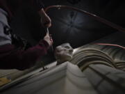 Washington National Cathedral stone carver Sean Callahan uses an air chisel to work on a sculpture of Holocaust survivor and Nobel Peace Prize winning author Elie Wiesel at the cathedral, Thursday, March 25, 2021. Wiesel, who died in 2016, became an outspoken advocate for human rights causes around the world, helped found the United States Holocaust Memorial Museum and was awarded the Nobel Peace Prize in 1986.