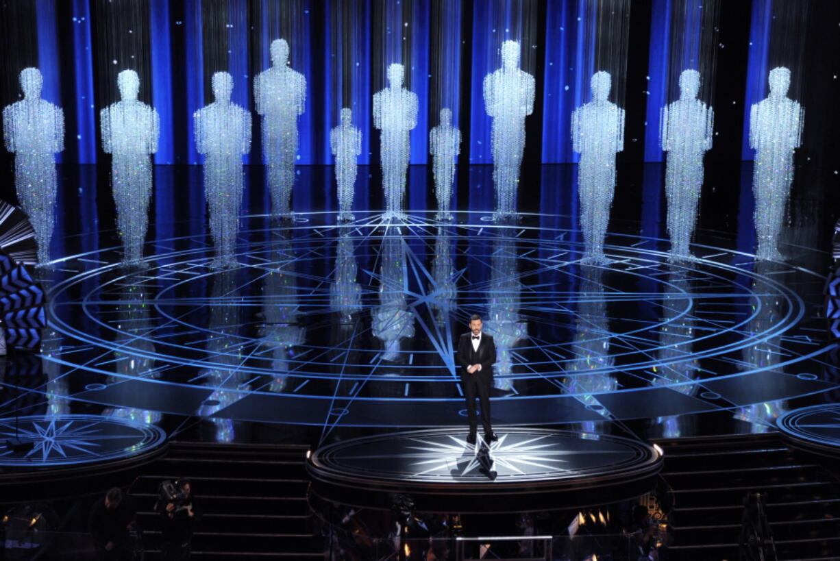 FILE - In this Feb. 26, 2017 file photo, host Jimmy Kimmel speaks at the Oscars in Los Angeles. Some people watch awards shows out of love, others because they love to hate. But this year, as ratings have taken a dive, will anybody tune in to the Oscars? Pushed by the pandemic from its usual berth of February or early March, the Academy Awards will be presented April 25 on ABC.