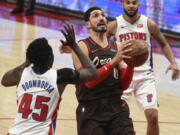 Portland Trail Blazers center Enes Kanter drives to the basket on Detroit Pistons forward Sekou Doumbouya, left, during the second half of an NBA basketball game in Portland, Ore., Saturday, April 10, 2021. The Blazers won 118-103.