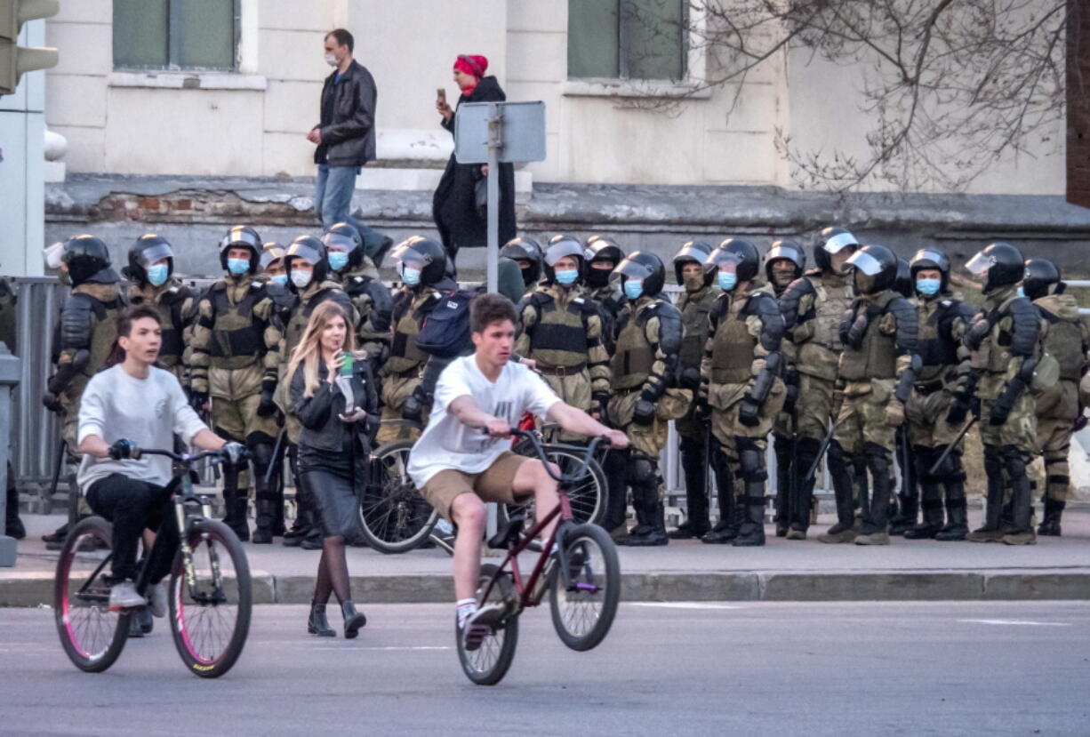 Russian policemen stand in preparation for a possible opposition rally in support of jailed opposition leader Alexei Navalny in Khabarovsk, 6,100 kilometers (3,800 miles) east of Moscow, Russia, Wednesday, April 21, 2021. Navalny's team has called for nationwide protests on Wednesday following reports that the politician's health was deteriorating in prison, where he has been on hunger strike since March 31. Russian authorities have stressed that the demonstrations were not authorized and warned against participating in them.