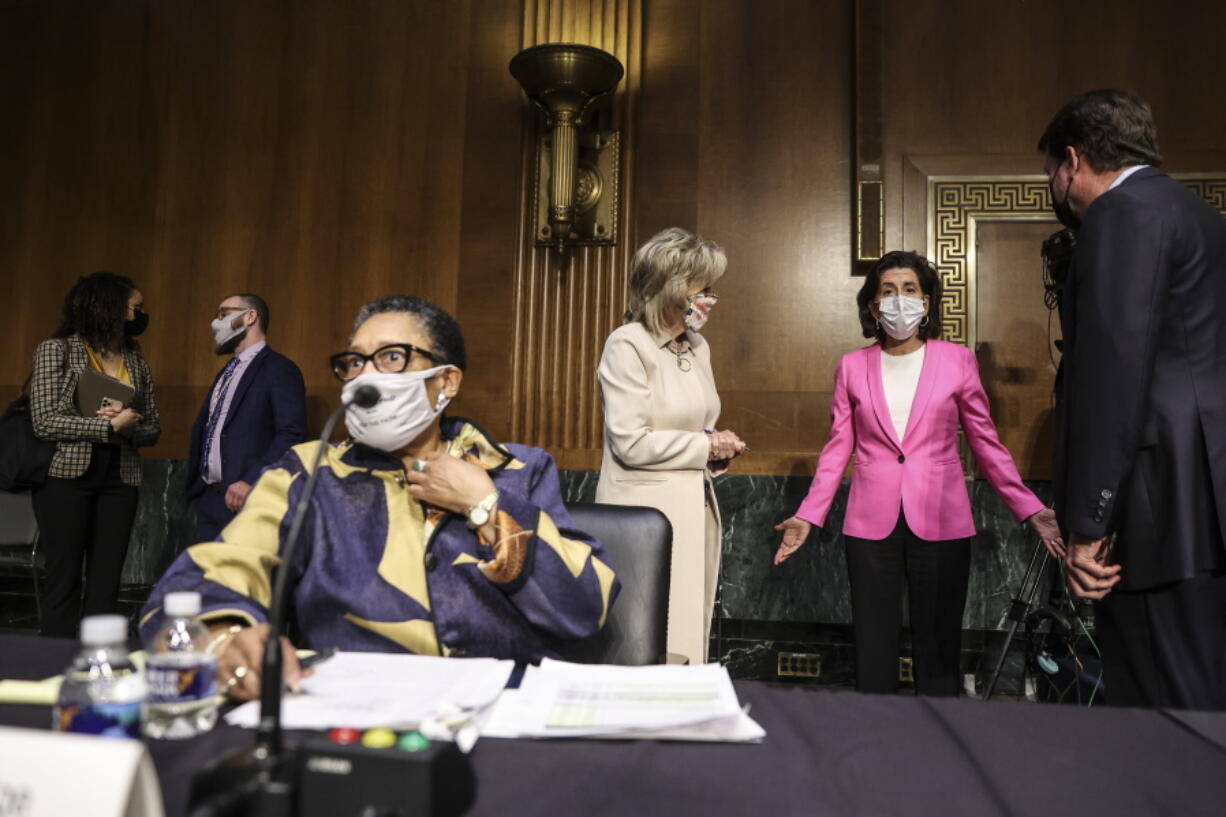 Commerce Secretary Gina Raimondo, second right, speaks with, Sen. Cindy Hyde-Smith, R-Miss., and Sen. Bill Hagerty, R-Tenn., right, as Housing and Urban Development Secretary Marcia Fudge, left, arrives for a Senate Appropriations Committee hearing on Capitol Hill, Tuesday, April 20, 2021 in Washington.