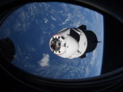 In this Saturday, April 24, 2021 photo made available by NASA, the SpaceX Crew Dragon capsule approaches the International Space Station for docking. SpaceX's four astronauts had barely settled into orbit on Friday, April 23, when they were ordered back into their spacesuits because of a potential collision with orbiting junk. It turns out there was no threat, the U.S. Space Command acknowledged Monday, April 26. The error is under review.