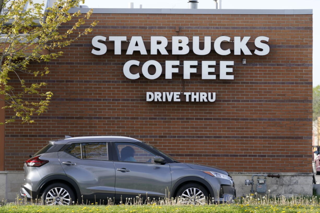 A customers exits the drive thru lane at a Starbucks coffee shop, Tuesday, April 27, 2021, in Des Moines, Iowa. After four straight quarters of sales declines, Starbucks returned to growth in the January-March period.