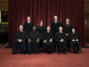 FILE - In this April 23, 2021, file photo members of the Supreme Court pose for a group photo at the Supreme Court in Washington. Seated from left are Associate Justice Samuel Alito, Associate Justice Clarence Thomas, Chief Justice John Roberts, Associate Justice Stephen Breyer and Associate Justice Sonia Sotomayor, Standing from left are Associate Justice Brett Kavanaugh, Associate Justice Elena Kagan, Associate Justice Neil Gorsuch and Associate Justice Amy Coney Barrett. Before the Supreme Court this is week is an argument over whether public schools can discipline students over something they say off-campus.