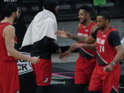 Portland Trail Blazers forward Norman Powell (24) and guard CJ McCollum, second from right, celebrate their win against the San Antonio Spurs with teammates Enes Kanter (11) and Carmelo Anthony, second from left, during the second half of an NBA basketball game in San Antonio, Friday, April 16, 2021.