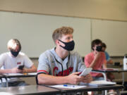 Lucas Warner, center, focusses during a calculus class taught by Craig Hardin at Camas High School on Monday. Camas returned to four-day-a-week in-person instruction on Monday.