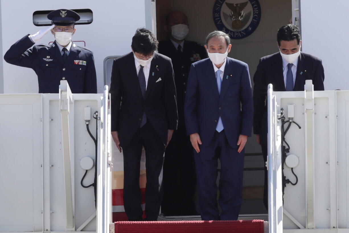 Japanese Prime Minister Yoshihide Suga boards his plane to depart at Andrews Air Force Base, Md., Saturday, April 17, 2021, after his visit to Washington. (AP Photo/Luis M.