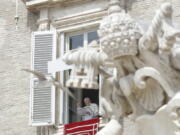 Pope Francis delivers his blessing as he recites the Regina Caeli noon prayer from the window of his studio overlooking St.Peter's Square, at the Vatican, Sunday, April 18, 2021. Pope Francis said he is happy to be back greeting the faithful in St. Peter's Square faithful for his traditional Sunday noon blessing after weeks of lockdown measures.