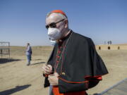 FILE - In this file photo taken on March 6, 2021, Vatican Secretary of State Cardinal Pietro Parolin arrives ahead of an interreligious meeting with Pope Francis near the archaeological area of the Sumerian city-state of Ur, 20 kilometers south-west of Nasiriyah, Iraq. The Vatican No. 2 is skipping a planned trip to Venezuela this week because of the coronavirus pandemic. Cardinal Pietro Parolin, the Vatican's former ambassador to Caracas, had planned to celebrate the April 30 beatification of Jose Gregorio Hernandez, dubbed the "doctor of the poor." The Vatican said Wednesday that due to issues linked to the pandemic, Parolin wouldn't make the trip.