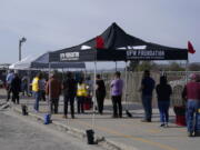 FILE - In this March 3, 2021, file photo, farmworkers wait in line to receive the Moderna COVID-19 vaccine at a County of Santa Clara mobile vaccination clinic at Monterey Mushrooms, an agricultural employer under the United Farm Workers union contract, in Morgan Hill, Calif.