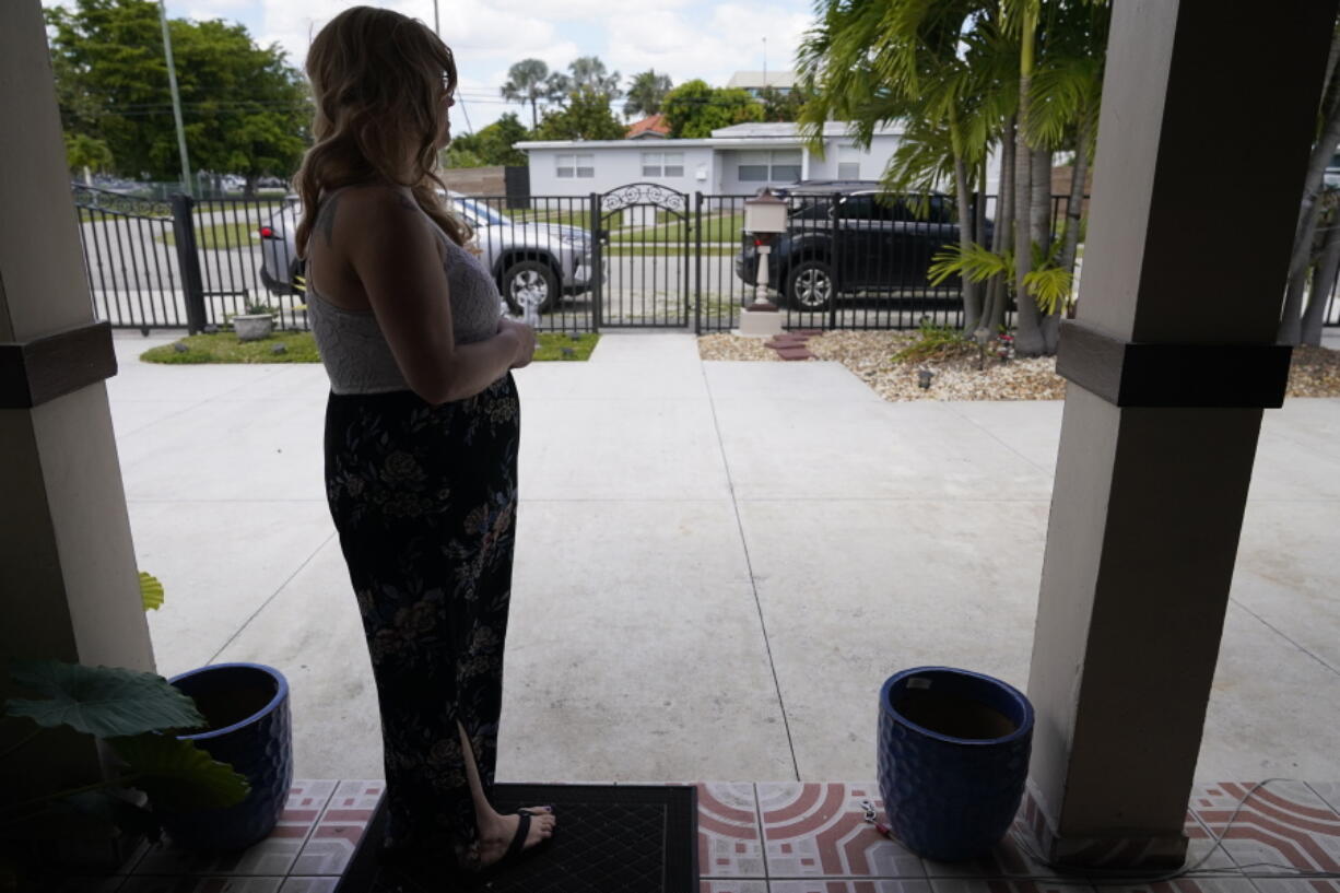 Nicole Russell looks out from her porch, Friday, March 12, 2021, in Kendall, Fla. Because of the pandemic, Nicole because fearful of leaving her home and retreated to her bedroom for days at a time. While some felt restricted by the confinement of home &quot;caves&quot;, others found a sense of safety and comfort, becoming increasingly accustomed to the isolation.