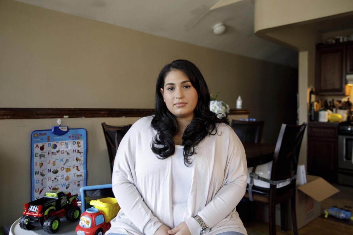 Priscilla Medina poses for a portrait in her home in Queens in New York on Wednesday, April 7, 2021. After being exposed and suffering severe symptoms from COVID-19, If Medina had gotten COVID-19 a year earlier, she would have had no treatments proven safe and effective to try. But when the 30-year-old nurse arrived at a Long Island hospital in March 2021, so short of breath she could barely talk, doctors knew just what to do. They quickly arranged for her to get a novel drug that supplies virus-blocking antibodies, and "by the next day I was able to get up and move around," she said. After two days, "I really started turning the corner.