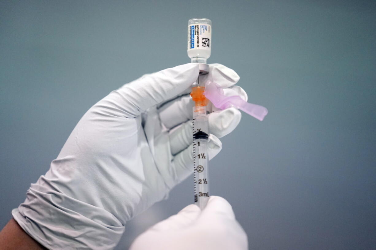 A member of the Philadelphia Fire Department prepares a dose of the Johnson &amp; Johnson COVID-19 vaccine March 26 at a vaccination site set up at a Salvation Army location in Philadelphia.