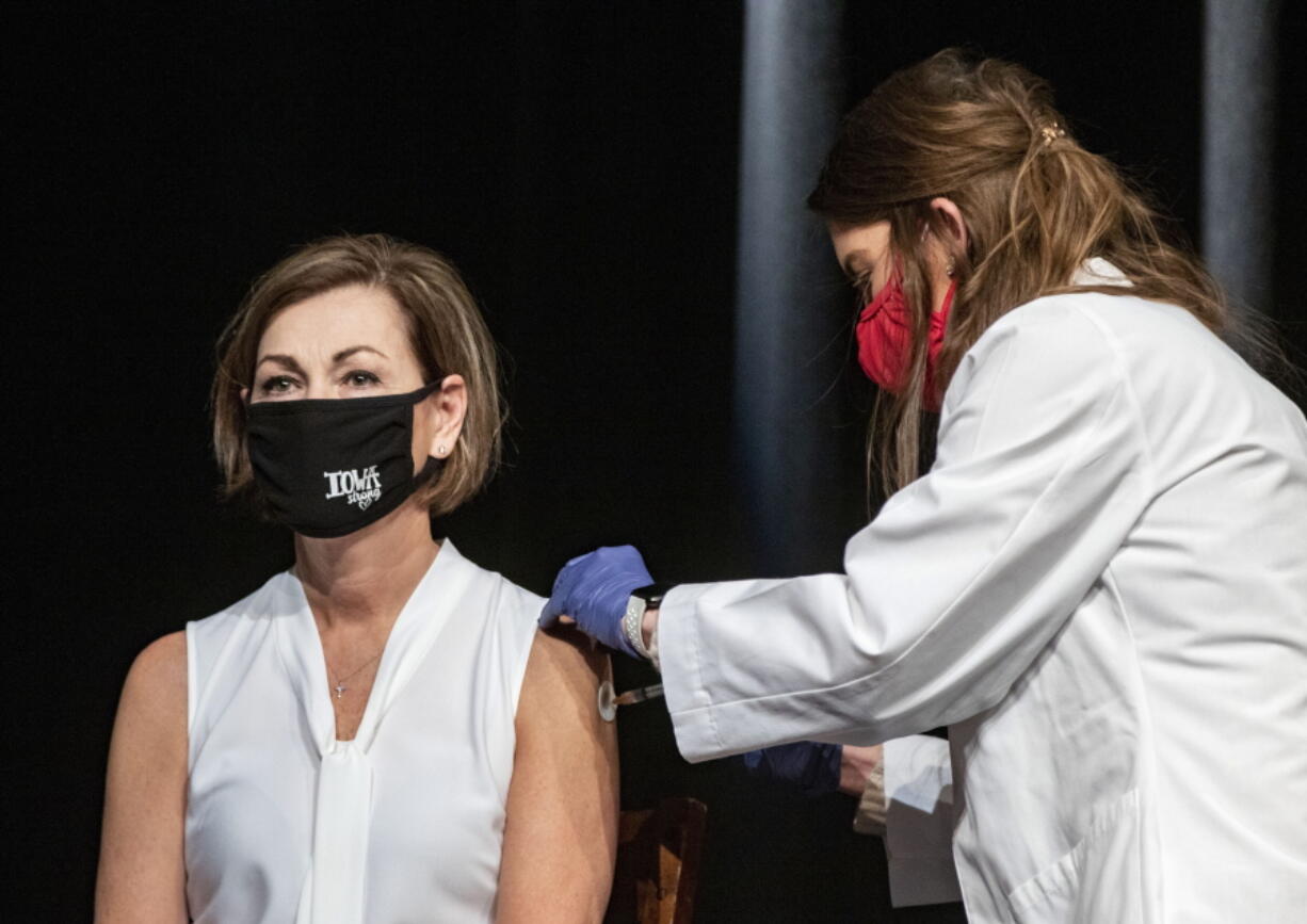 FILE - In this March 3, 2021, file photo, Iowa Governor Kim Reynolds gets the Johnson &amp; Johnson COVID-19 vaccine during a news conference at Iowa PBS in Johnston, Iowa. Reynolds, a Republican, is trying win over the one-third of adult Iowans who won&#039;t commit to getting a vaccine by emphasizing that the shots will help return life to normal. A new poll from The Associated Press-NORC Center for Public Affairs Research shows that the percentage of Americans resisting getting inoculated has shrunk in the past few months. But it&#039;s still not enough to pull America out of the pandemic, and reach herd immunity.