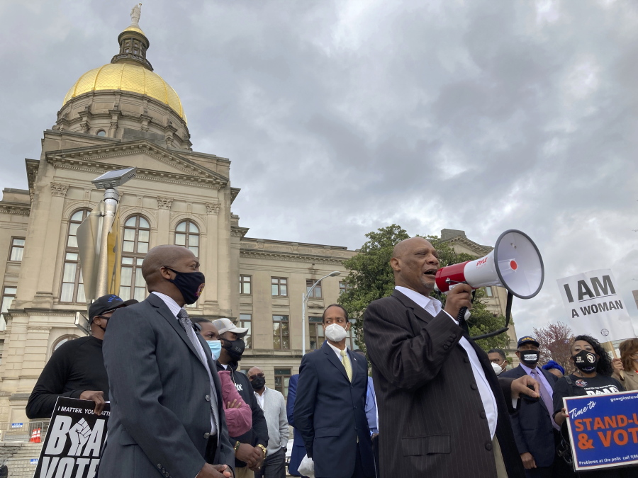 FILE - In this March 25, 2021, file photo African Methodist Episcopal Church Bishop Reginald Jackson announces a boycott of Coca-Cola Co. products outside the Georgia Capitol n Atlanta.