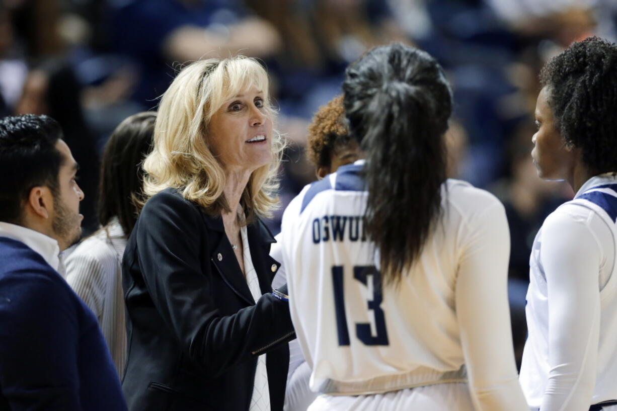 FILE - In this Nov. 17, 2019, file photo, Rice head coach Tina Langley talks with her players during a timeout in the second half of an NCAA college basketball game against Texas A&amp;M in Houston. Washington hired Langley as its new women&#039;s basketball coach Monday, April 5, 2021, giving one of the top coaches in Conference USA over the past six seasons her first shot at leading a Power Five program.