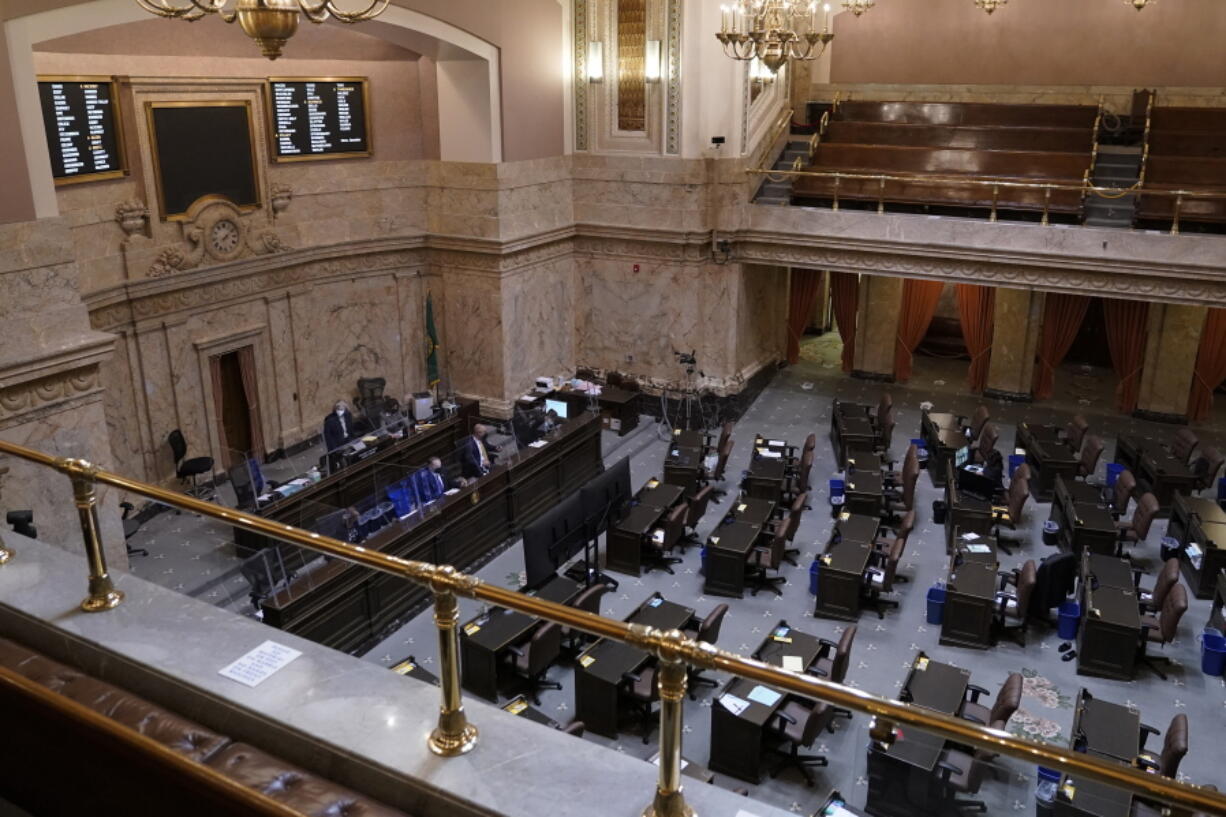 Speaker of the House Laurie Jinkins, D-Tacoma, left, presides over a session of the House, with most representatives attending remotely, on April 22 at the Capitol in Olympia. (AP Photo/Ted S.