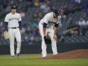 Seattle Mariners starting pitcher James Paxton, right, reacts near the mound after experiencing an injury during the second inning of a baseball game against the Chicago White Sox, Tuesday, April 6, 2021, in Seattle. Paxton left the game and the White Sox won 10-4. (AP Photo/Ted S.