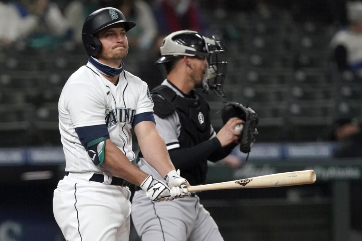 Seattle Mariners&#039; Kyle Seager reacts after striking out swinging to end the third inning as Chicago White Sox catcher Yasmani Grandal holds the ball during a baseball game, Monday, April 5, 2021, in Seattle. (AP Photo/Ted S.