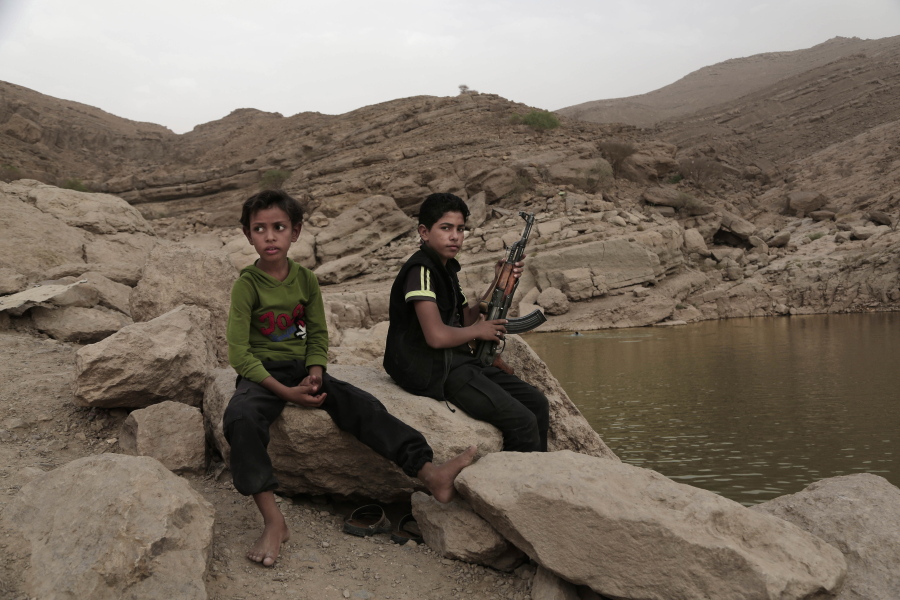 FILE - In this July 30, 2018, file photo, a 17-year-old boy holds his weapon at the dam in Marib, Yemen. The battle for the ancient desert city has become key to understanding wider tensions now inflaming the Middle East and the challenges facing any efforts by President Joe Biden&#039;s administration to shift U.S. troops out of the region.