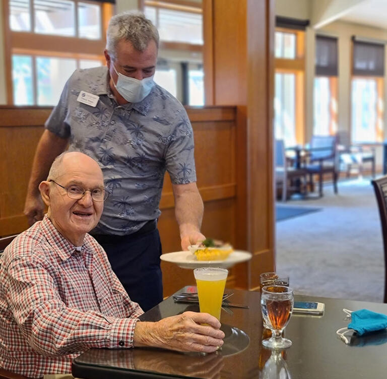 Paul serving food at The Quarry Senior Living