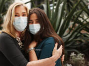 Peggy Kelley, left, a Protestant Christian chaplain stands with Jillian Katz, an Orthodox Jewish nurse on Cedars-Sinai's COVID-19 unit, in the Healing Gardens on March 12 in Los Angeles, Calif. Usually, chaplains focus on providing spiritual care for patients and their families but since the pandemic, health care staff like Katz, have been needing them more.