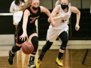 Washougal's Savea Mansfield (3) dribbles down the court while being defended by Hudson's Bay's Paytin Ballard (21) during the third quarter of a girl's high school basketball game at Hudson's Bay High School on Wednesday.