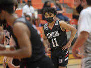 Union's Izaiah Vongnath (center) joins teammates in the second quarter against Battle Ground at Battle Ground High School on Tuesday night, May 11, 2021.