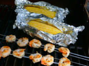 Grilled shrimp kabobs and grilled corn on the cob.