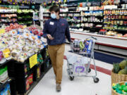 Johnny Grizzard, grocery manager at the Carlie C's IGA in Angier, N.C., fulfills an online order while working Tuesday, April 14, 2020.