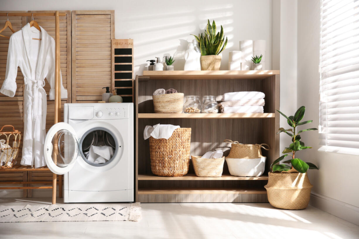 One way to make a laundry room feel welcoming is to incorporate cabinetry and shelving to stay organized.