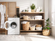 One way to make a laundry room feel welcoming is to incorporate cabinetry and shelving to stay organized.