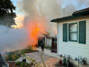 A detached garage behind a house at 2715 P Street in Vancouver went up in flames on Sunday morning.