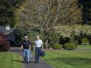 Richard Moody, 75, left, and his husband, Carl Caspersen, walk near their home in southeast Vancouver. Moody, who has lived 26 years with a transplanted heart, is careful to lead a healthy lifestyle and walks daily.