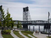 Pedestrians enjoy sunny conditions with a view of the Interstate 5 Bridge at The Waterfront Vancouver. It's been eight years since the collapse of the Columbia River Crossing project and two years since Washington and Oregon embarked on a renewed attempt to develop a replacement for the aging pair of spans, dubbed the Interstate Bridge Replacement Program.