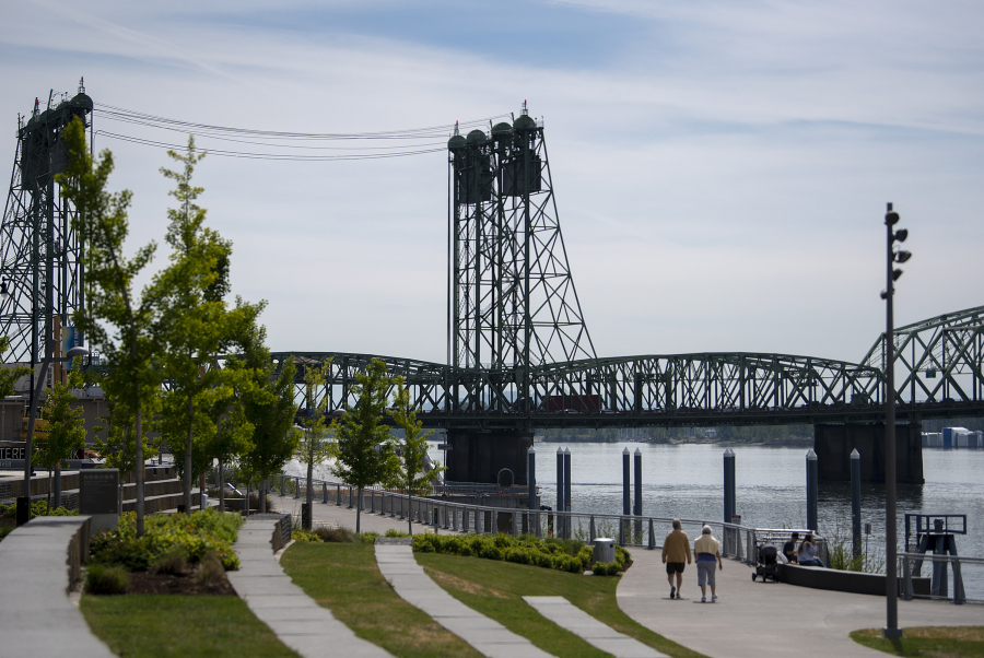 Pedestrians enjoy sunny conditions with a view of the Interstate 5 Bridge at The Waterfront Vancouver. It's been eight years since the collapse of the Columbia River Crossing project and two years since Washington and Oregon embarked on a renewed attempt to develop a replacement for the aging pair of spans, dubbed the Interstate Bridge Replacement Program.