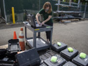 Geophysicist Rebecca Kramer charges batteries for high-precision GPS equipment at USGS Cascades Volcano Observatory in Vancouver late last month. Staff was packing up monitoring gear being shipped to be used in studies of the volcanic system at Yellowstone National Park.