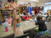 Kindergartner Emily Christel, foreground, joins classmates during in-person learning at Eisenhower Elementary School on Monday, the first day of expanded in-person instruction at Clark County's second-largest district.