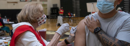 Medical Reserve Corps volunteer Ruth Gorley gives Vancouver resident Ryan Tydingco a Johnson & Johnson COVID-19 vaccine May 8 at Clark County Public Health's short-term vaccination pod at Woodland High School. After an early rush of people, the flow had slowed down by the late morning for the drop-in vaccination event.