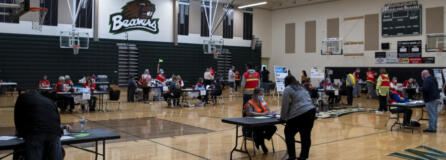 Volunteer and Clark County Public Health workers administer vaccines at Public Health's COVID-19 short-term vaccination pod at Woodland High School on May 8. Public Health administered 144 doses of Pfizer's vaccine at the event, and 183 doses of Johnson & Johnson's one-shot vaccine.