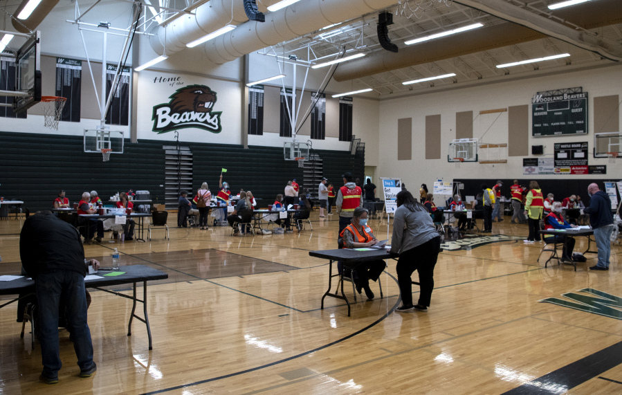 Volunteer and Clark County Public Health workers administer vaccines at Public Health's COVID-19 short-term vaccination pod at Woodland High School on May 8. Public Health administered 144 doses of Pfizer's vaccine at the event, and 183 doses of Johnson & Johnson's one-shot vaccine.