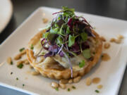 A Walla Walla sweet onion tart dish at Roots Restaurant and Bar in Camas.