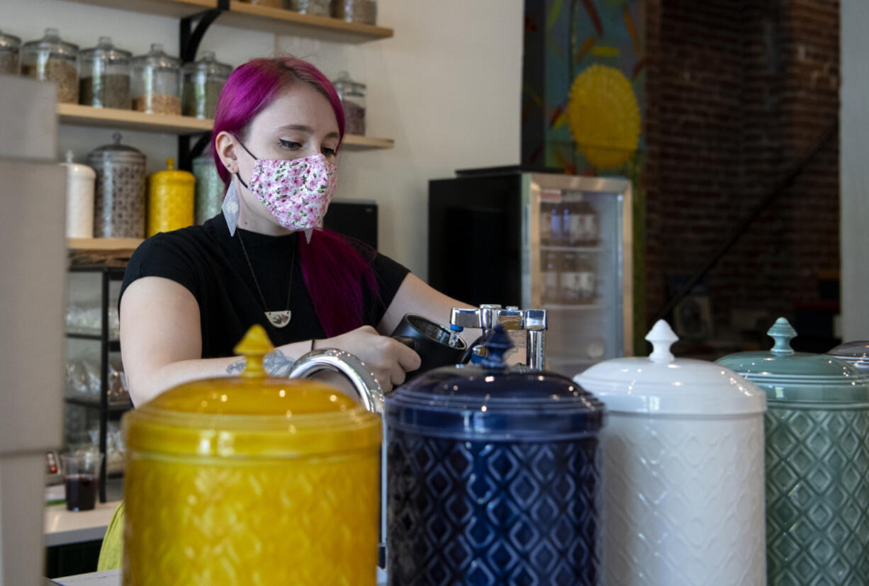 Co-owner Kat Stein fills a kettle at the Dandelion Teahouse & Apothecary soft opening in downtown Vancouver.