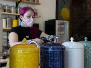 Co-owner Kat Stein fills a kettle at the Dandelion Teahouse & Apothecary soft opening in downtown Vancouver.