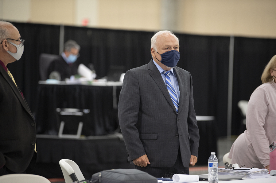 Don Benton, center, joins others as they wait for prospective jurors to enter the room during the lawsuit trial Tuesday afternoon at the Clark County Event Center at the Fairgrounds.