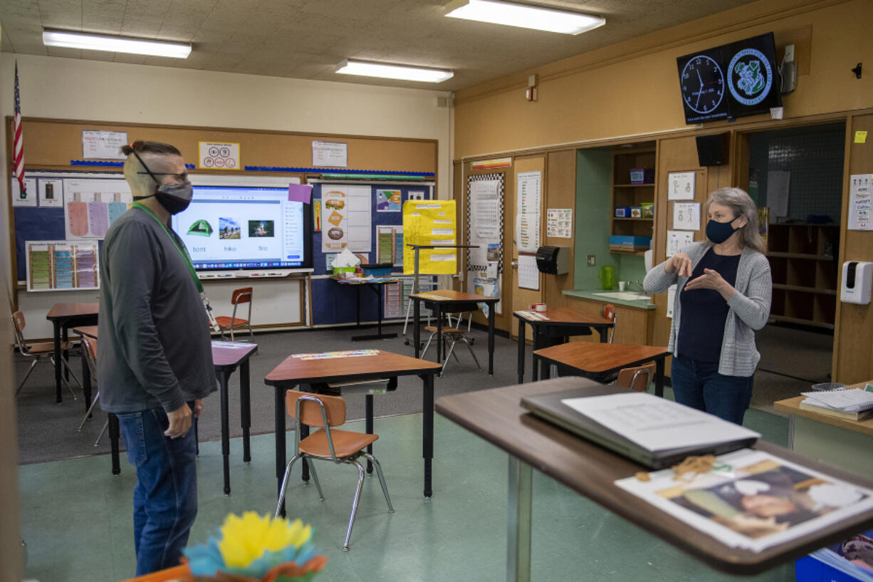 Teachers Taylor Seidel, left, and Stephanie Alves deLima have a conversation inside Northrop Primary School at the Washington School for the Deaf. Northrop -- soon to become the oldest building on the campus -- has earned a spot on the National Register of Historic Places and the Washington Heritage Register.