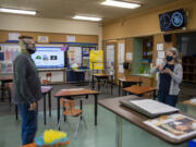 Teachers Taylor Seidel, left, and Stephanie Alves deLima have a conversation inside Northrop Primary School at the Washington School for the Deaf. Northrop -- soon to become the oldest building on the campus -- has earned a spot on the National Register of Historic Places and the Washington Heritage Register.