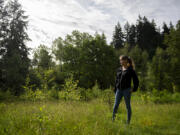 Sunrise O'Mahoney, executive director of the Watershed Alliance of Southwest Washington, shows an area of the Burnt Bridge Creek Greenway that honors the memory of local people of color who died from COVID-19. There are 41 trees planted there.