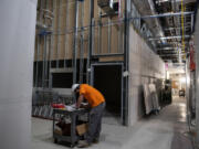 Brian Buck of Capitol Electric looks over plans while helping with the construction of the new Pacific Northwest Pet ER and Specialty Center. The 24-hour animal hospital and specialty veterinary care facility is under construction in east Vancouver in a building that formerly housed a Whole Foods Market.